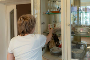 Woman reaching into cabinet