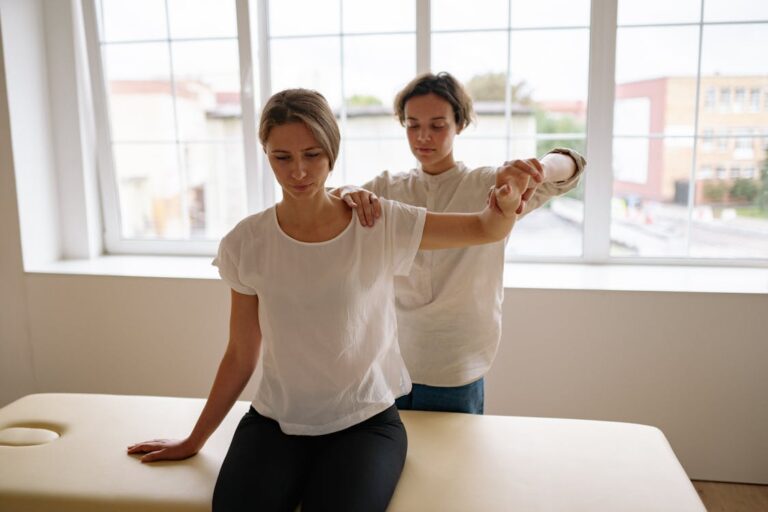 Physical therapist working one-on-one with patient in bright clinical setting