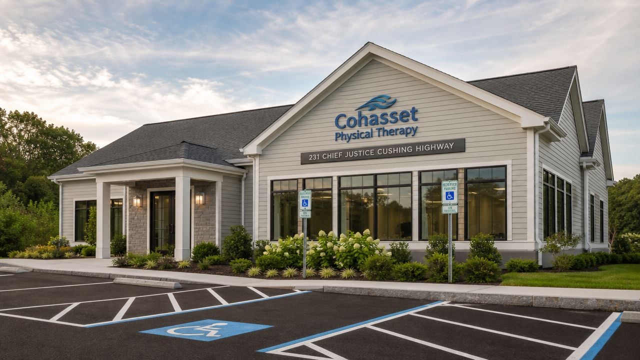 The exterior of the modern Cohasset Physical Therapy building featuring a landscaped parking lot and entrance.